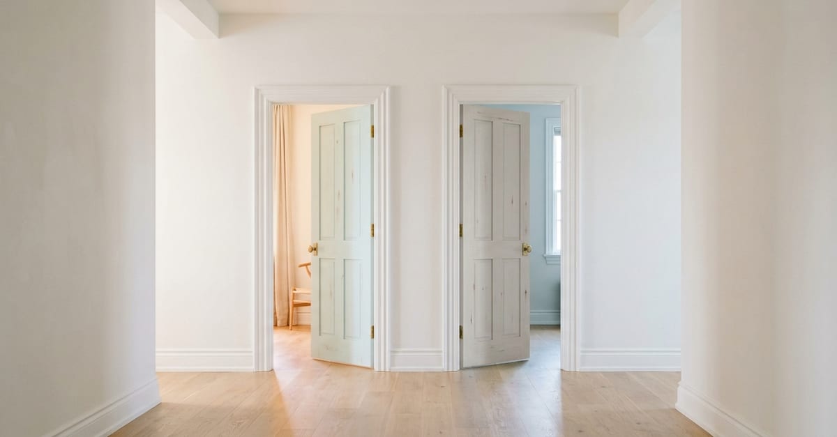 Two wooden doors side by side in a bright hallway, both slightly ajar, different light behind each